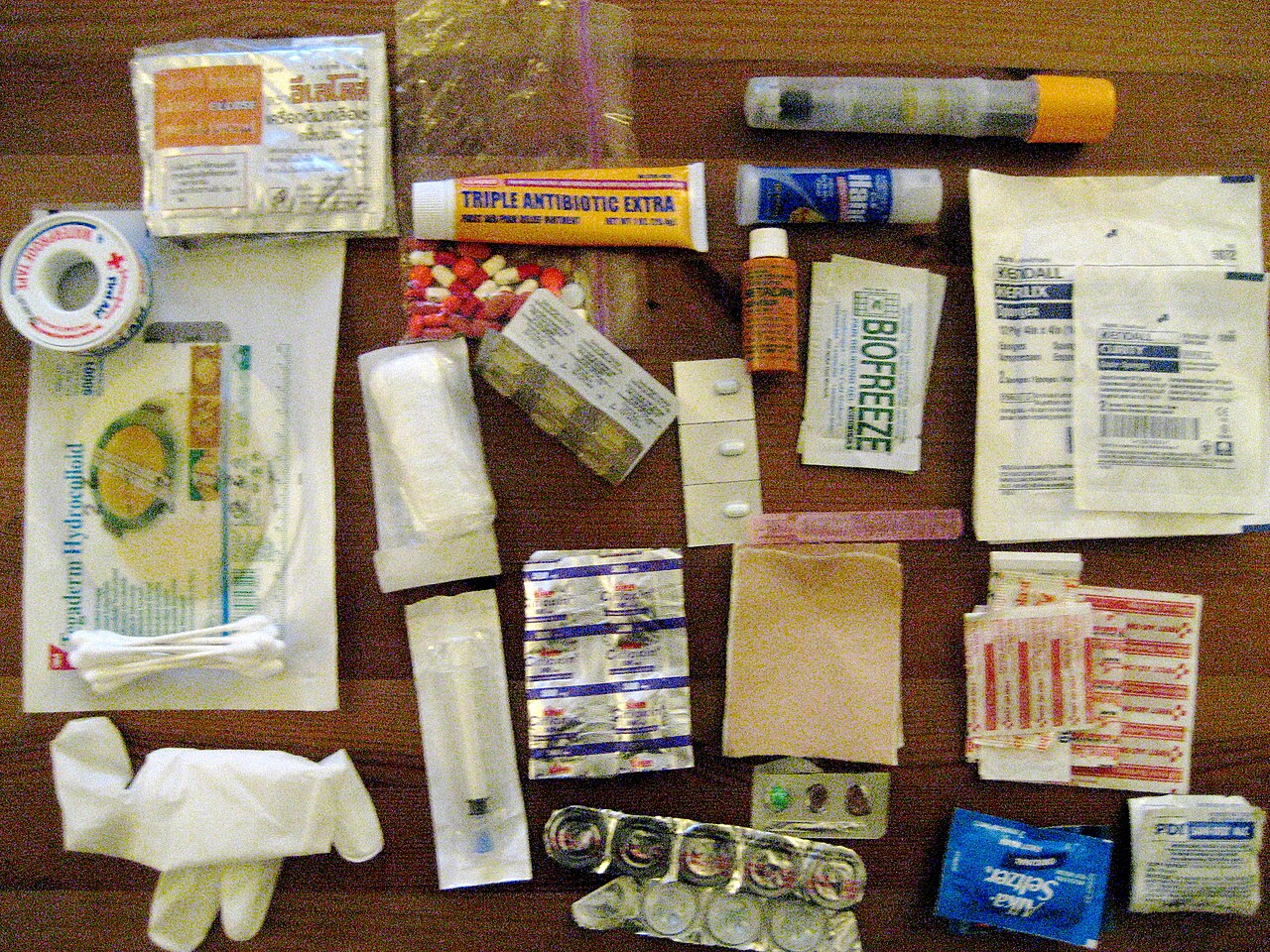 Ultralight first-aid supplies organized in a waterproof zipper pouch on a trail map